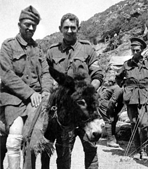 Old black and white photo with wounded soldier on a donkey and private Simpson to his right