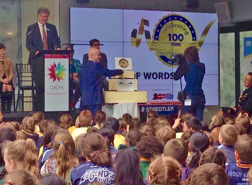 NSW education minister Adrian Piccoli cuts the 100th birthday cake for the school magazine
